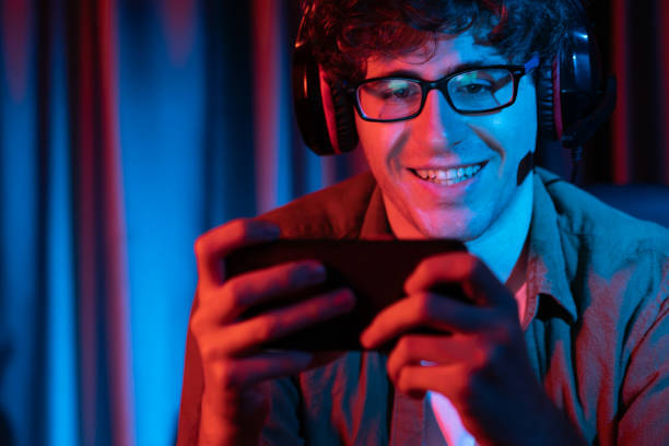 istock Smiling streamer team playing with Esport online on smartphone. Gusher. 2163367702