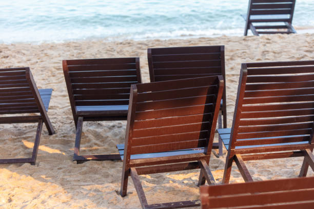 Colorful deckchairs and sun loungers on the beach by the sea