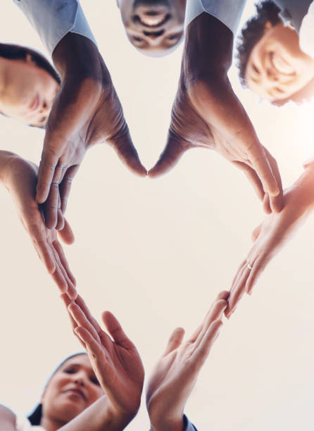 istock Heart, teamwork and hands of business people in support, unity or collaboration for diversity. Mockup, emoji and group of employees with love shape for trust, care and solidarity for company hope. 2163368619