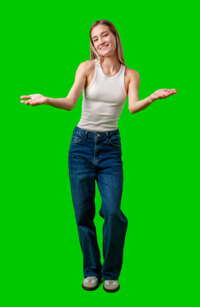 istock Young Woman Smiling and Gesturing With Open Palms Against a Green Screen 2163369216