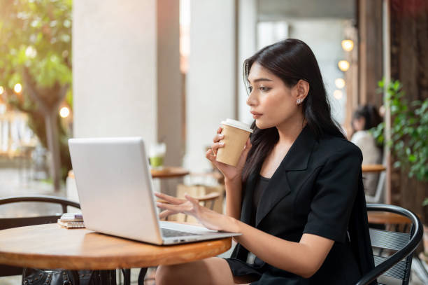 istock A focused Asian businesswoman is working on her computer, working remotely from a coffee shop. 2163371362