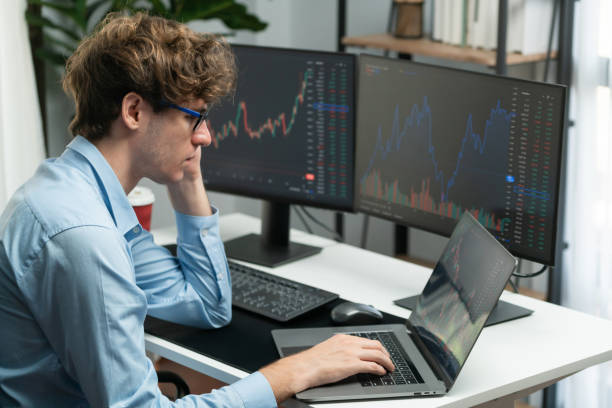 istock Working young business trader focusing stock graph on laptop. Gusher. 2163373294