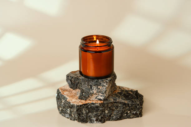 istock Glass Jar On Stacked Rocks Against Beige Background 2163373770