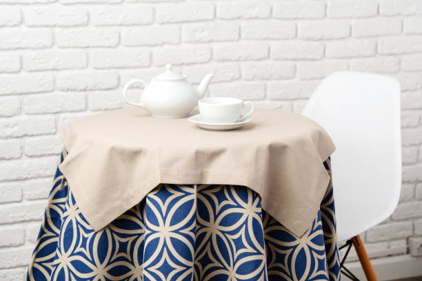 istock Blue And Tan Geometric Tablecloth On Round Table In Front Of White Brick Wall 2163373861