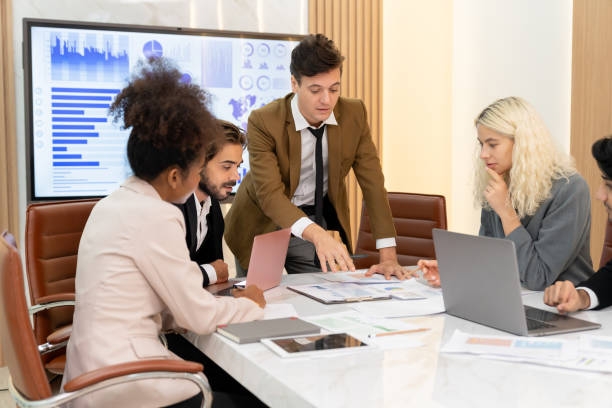 istock Professional smart business team discussion about start up project. Ornamented. 2163374644