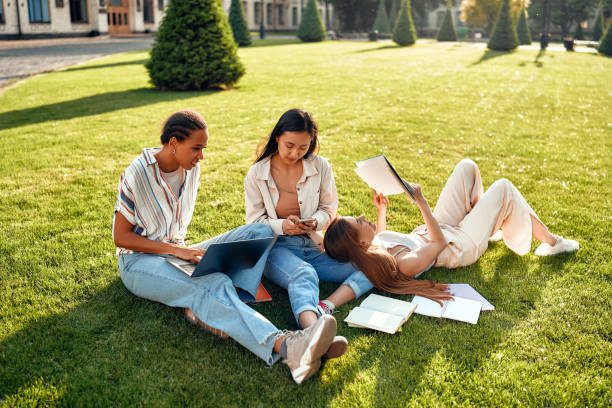 istock A group of diverse students is relaxing and studying on the university campus lawns 2163378103