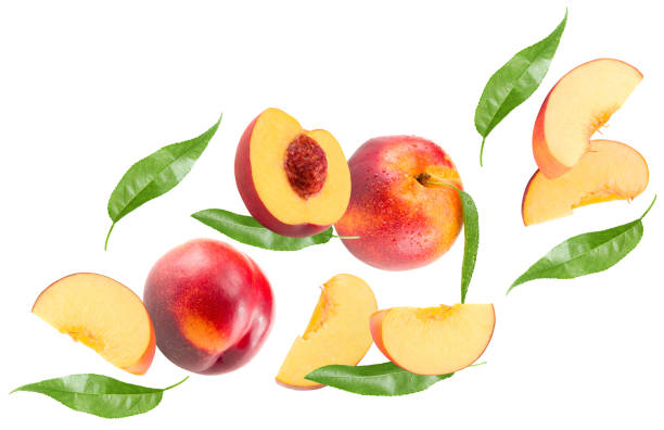 istock flying cuts of peach fruit with green leaf isolated on white background. clipping path 2163382989
