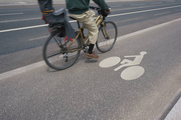 A cyclist on a bicycle lane in the city