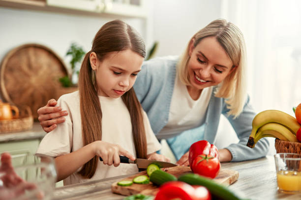istock Mother and daughter cooking together in a bright kitchen, enjoying creating meals side by side 2163384662