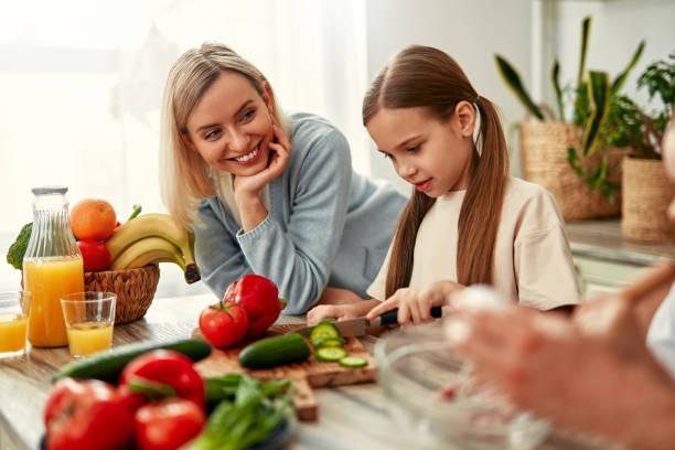 istock Mother and daughter cooking together in a bright kitchen, enjoying creating meals side by side 2163384667