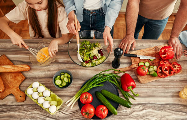 istock Family spends quality time making a nutritious salad in their contemporary kitchen 2163384795