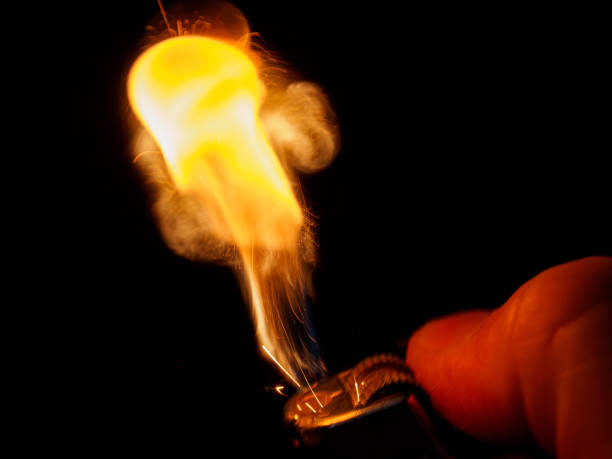 The lighter produces a spark, creating fire. Symbol of danger, potential explosion and fire. Ideal for warnings.
