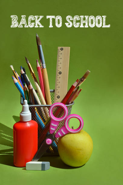 Bright school and office supplies including scissors, pens, pencils, sticky notes, paper clips, and markers scattered on a white surface.