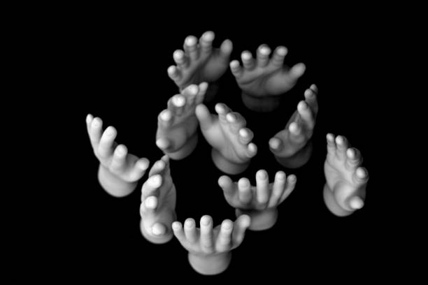 istock Toy hands on black background. Help, assistance, harmony, diversity concept; tiny finger hands. 2163387503