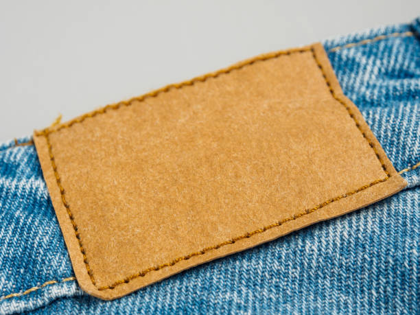 istock Blank clothing tag ready for personalization. Ideal element for fashion, branding and textile themes 2163388263