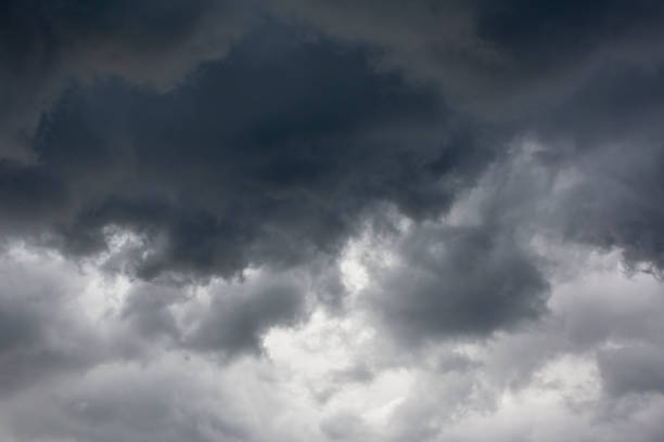 istock Dark gray clouds drift through the blue sky 2163389365