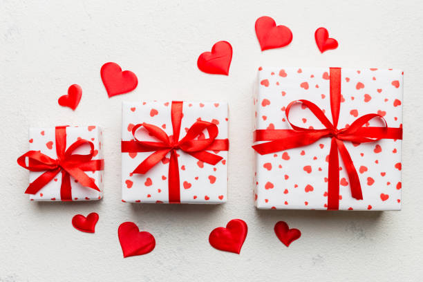 istock Valentine day composition Background: red gift box with bow and heart. Christmas present. View from above. Holday greeting card 2163389585