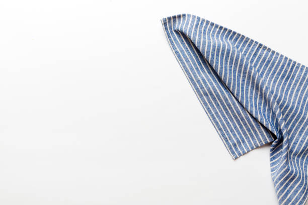 istock top view with blue kitchen napkin isolated on table background. Folded cloth for mockup with copy space, Flat lay. Minimal style 2163389743