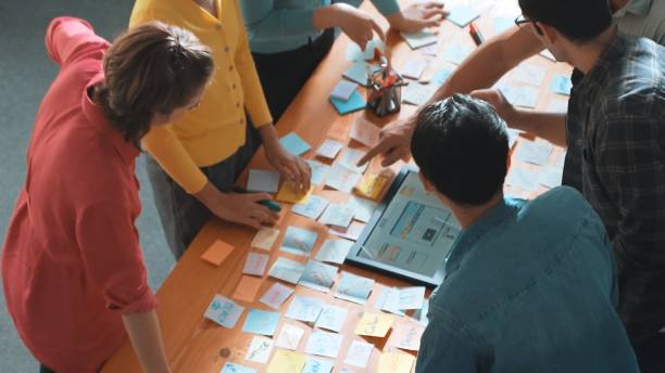 istock Top view of manager writing idea on sticky notes and explain idea. Symposium. 2163389788