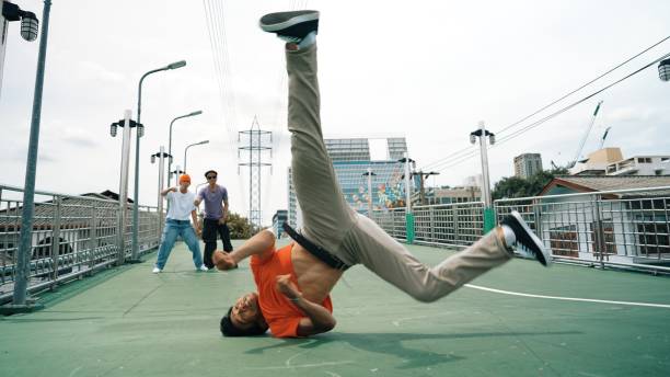istock Young happy hipster perform break dancing or foot step with friend. Sprightly. 2163392172