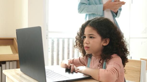 istock American girl learning about prompt while student sitting at class. Pedagogy. 2163393241