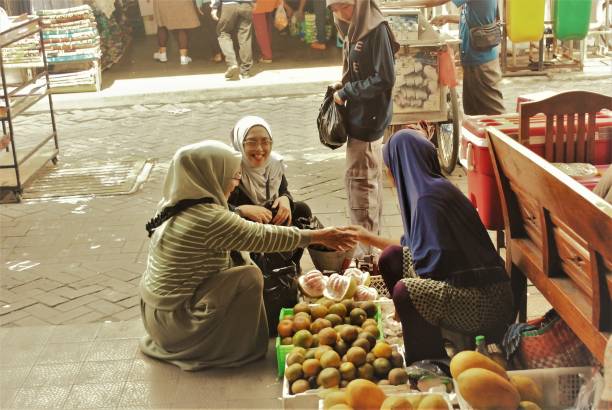 istock Hijab tourist buying oranges. 2163393851