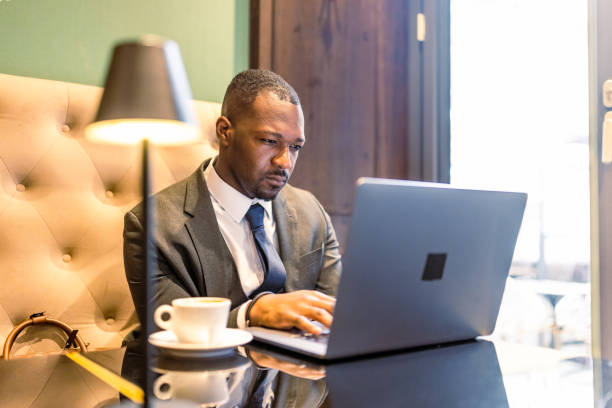 istock Businessman Working on Laptop in Cozy Cafe 2163394650