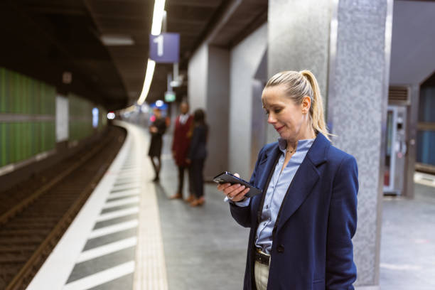 istock City Commuter Checking Phone on Train Platform in Morning 2163394751