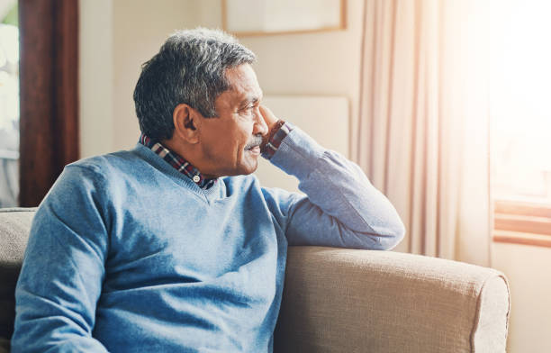 istock Thinking, depression and senior man in home to remember past memory, mistake or reflection of decision. Alzheimer, retirement and sad person on sofa with dementia, nostalgia or lonely in living room 2163395418