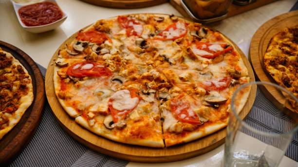istock Chicken and Mushroom Pizza on Wooden Board 2163395929