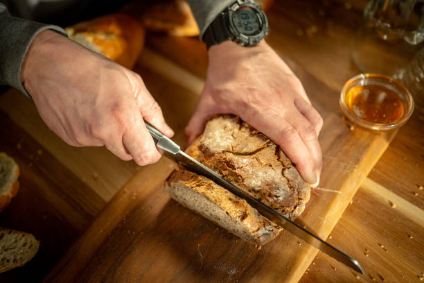 istock Slicing Freshly Baked Bread at Home 2163396882