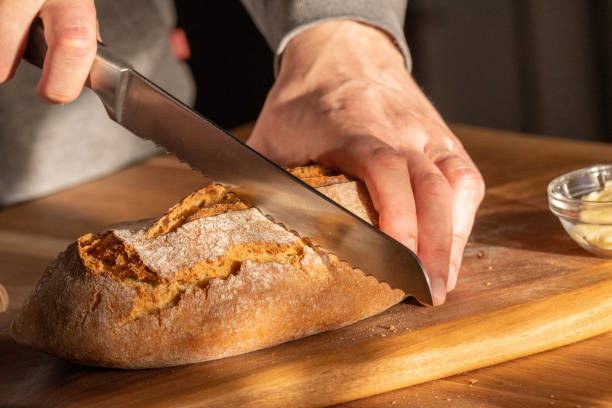 istock Fresh Loaf Slicing in Home Kitchen 2163396916