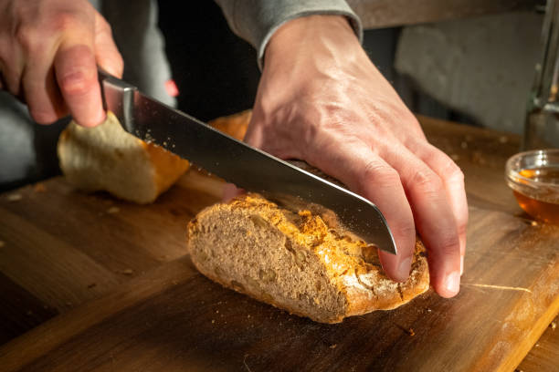 istock Slicing Fresh Bread in Home Kitchen 2163396917