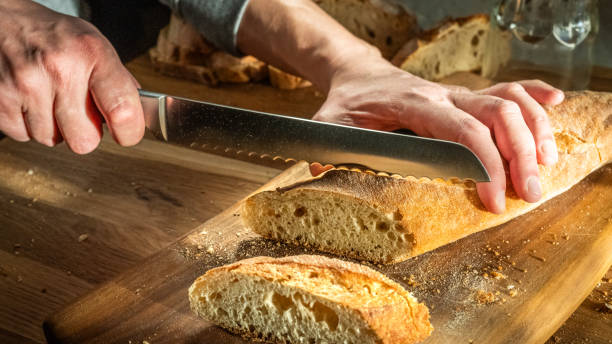 istock Fresh Bread Slicing in Home Kitchen 2163396962
