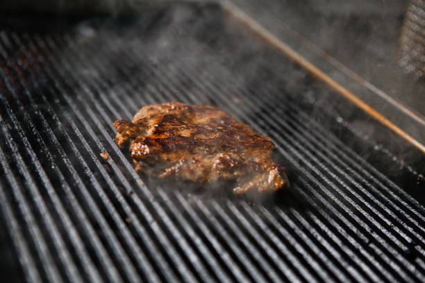 istock Steak Grilling on Hot Grill With Smoke 2163397676