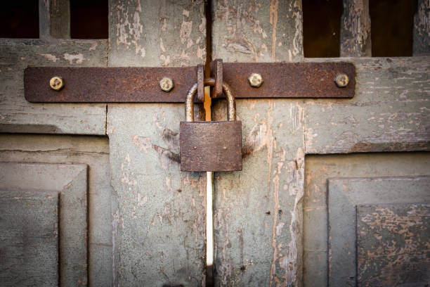 istock Rusty padlock on an ancient wooden door, historical design 2163397987