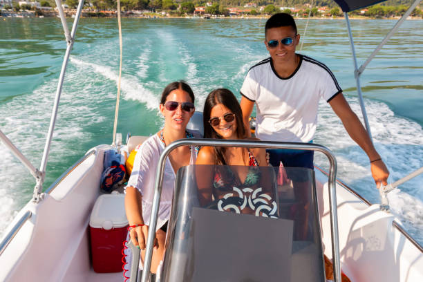Venice. Italy - October 08, 2025: A family with a young child enjoys a day out on a Sessa Key Largo 20 motorboat on the Venetian Lagoon.