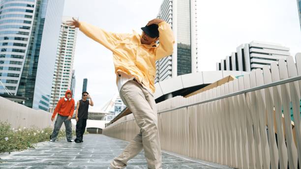 istock Hipster perform break dance while friend moving to music together. Sprightly. 2163402098