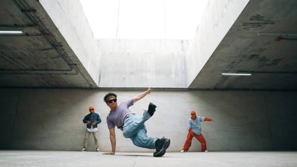 istock Group of stylish hipster group perform dancing together in building. Sprightly. 2163404099
