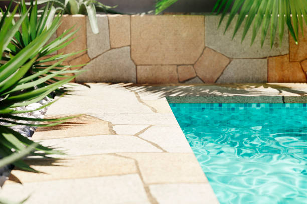 istock Luxury swimming pool with tropical plants and stone path. Poolside patio in mediterranean holiday villa. 2163404338