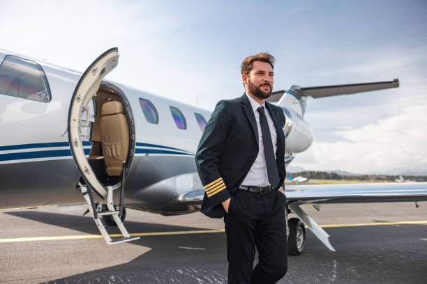 istock Confident Pilot Standing by Private Jet on Airport Tarmac 2163408163
