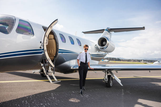 istock Confident Female Pilot by Private Jet at Airport 2163408200
