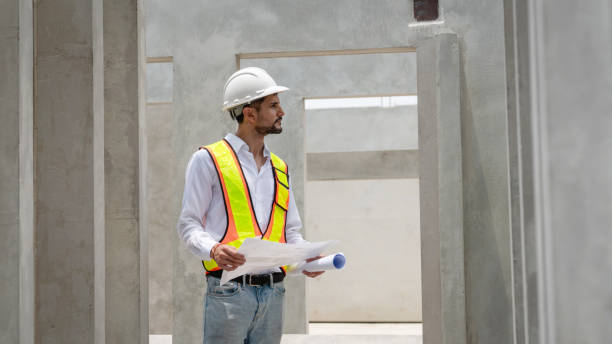 istock Engineers working on in construction gear are discussing at a concrete wall. 2163410319