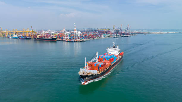 istock logistic cargo container ship sailing in sea import export goods and distributing products to dealer and consumers across worldwide, by container ship Transport business service 2163411617