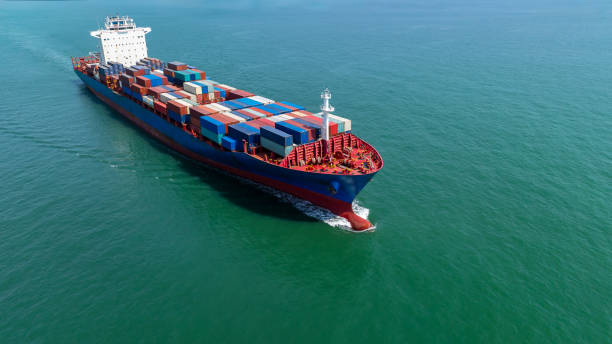 istock logistic cargo container ship sailing in sea import export goods and distributing products to dealer and consumers across worldwide, by container ship Transport business service 2163411618