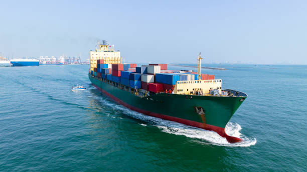 istock logistic cargo container ship sailing in sea import export goods and distributing products to dealer and consumers across worldwide, by container ship Transport business service 2163411624