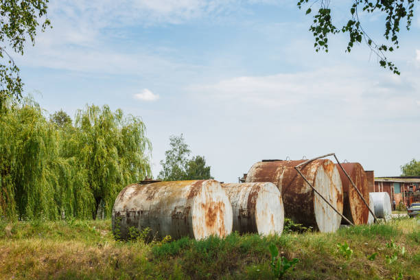 Old rusty fuel tanks in the yard. Clear sunny summer day