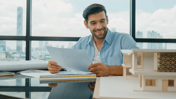 istock Skilled architect engineer writing house construction on blueprint. Disputation 2163414758