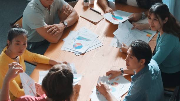 istock Top view of start up business team holding paper while discuss idea. Symposium. 2163414954
