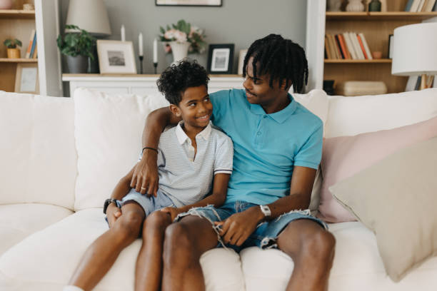 istock Happy brothers enjoying a moment on the white couch. 2163415911
